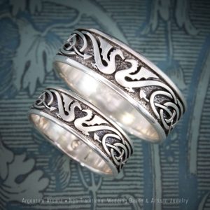 Pair of non-traditional matching wedding rings with Celtic Dragons and Celtic Knot motif