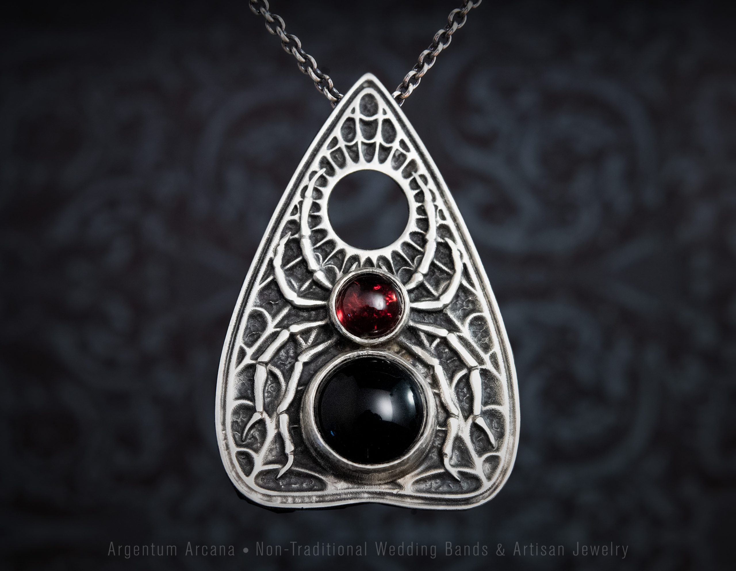 Silve Planchette with Spider Design with body made from black onyx and red garnet cabochons